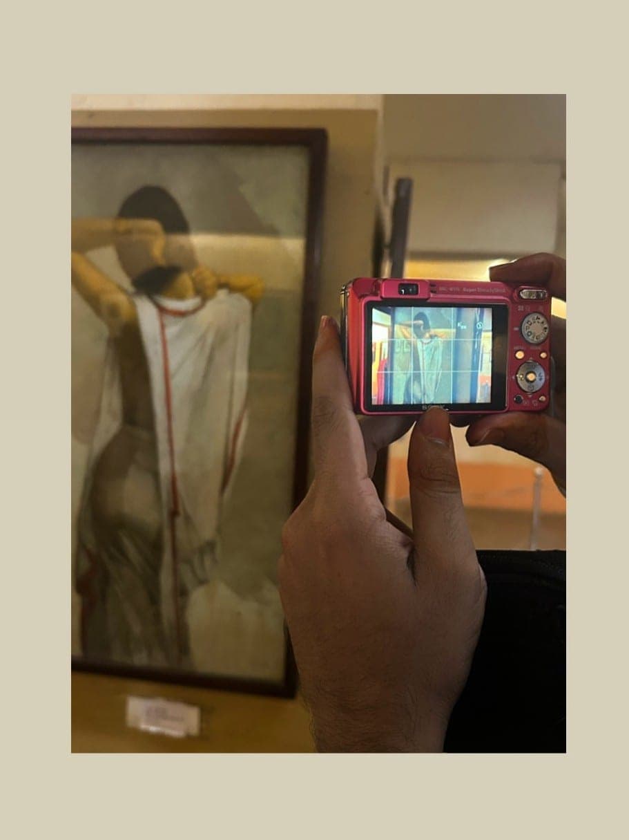 Photographing a framed painting with a small red digital camera